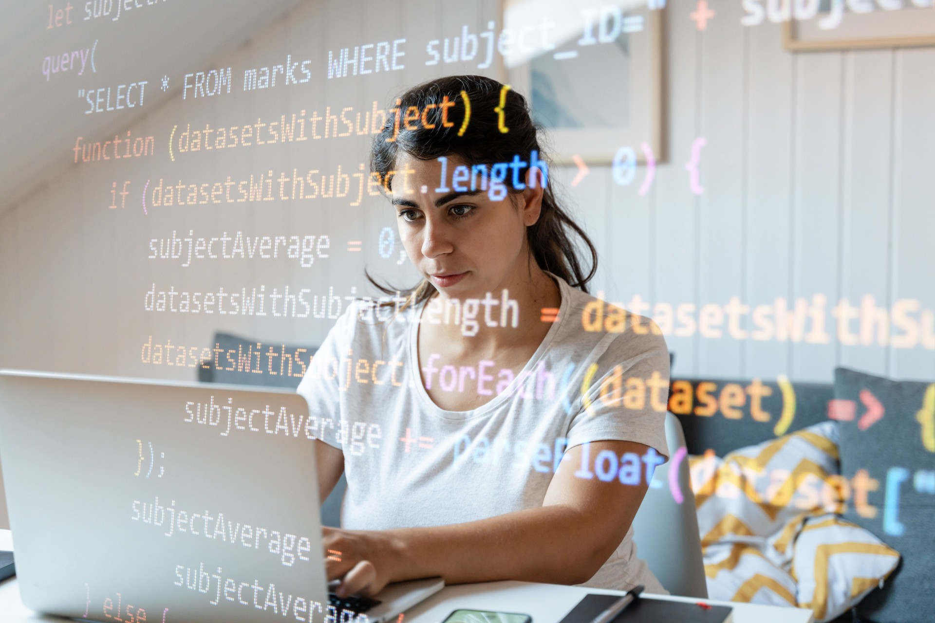 Attractive young woman using a laptop and looking at the screen with binary code